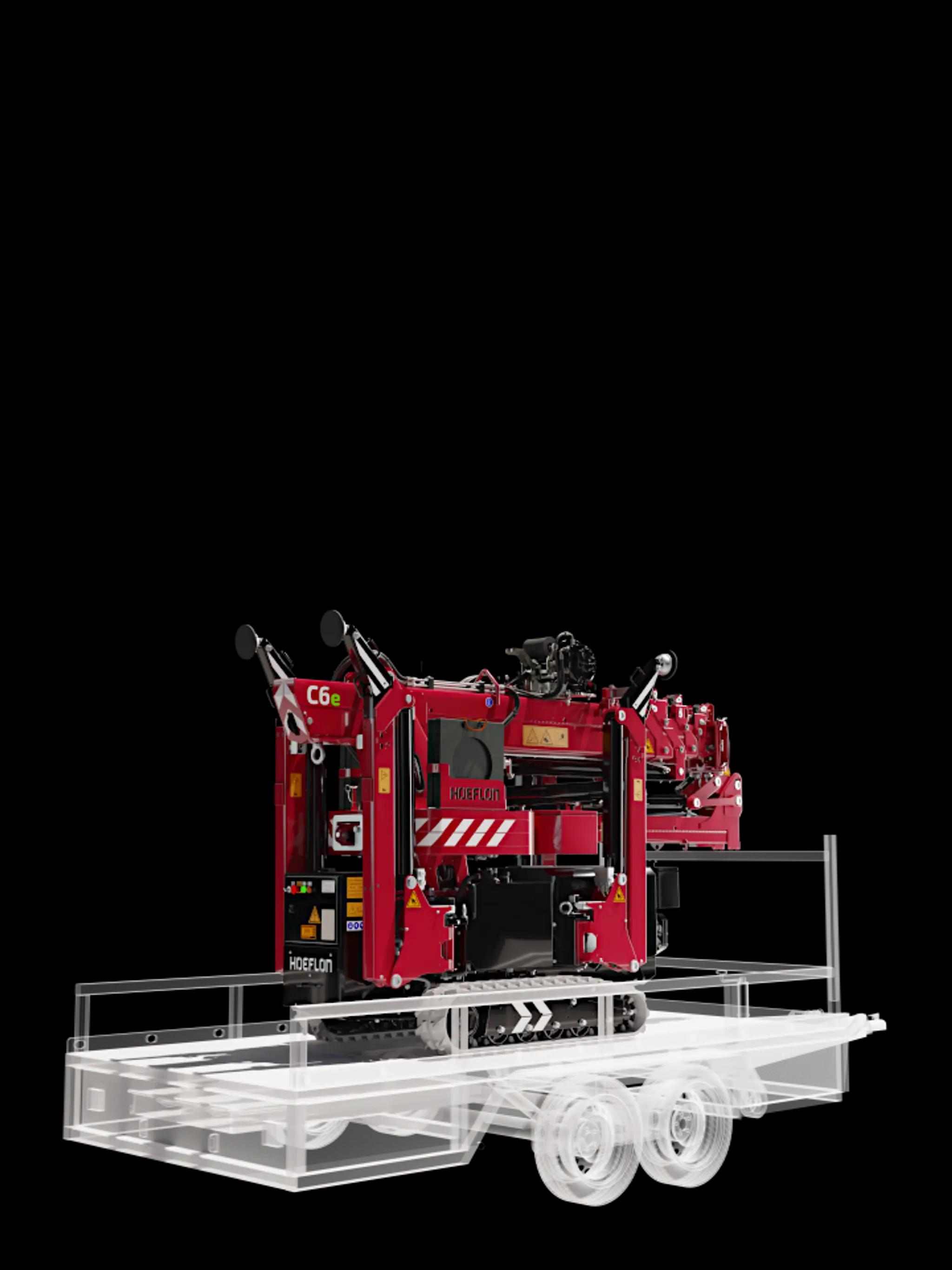 Hoeflon C6e en transport sur remorque compacte.
