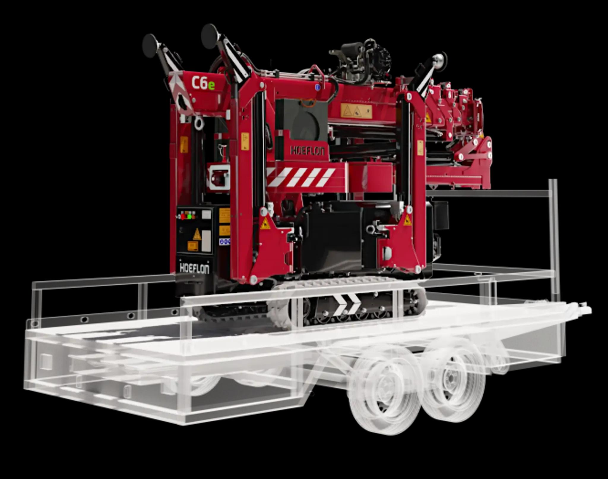 Hoeflon C6e en transport sur remorque compacte.